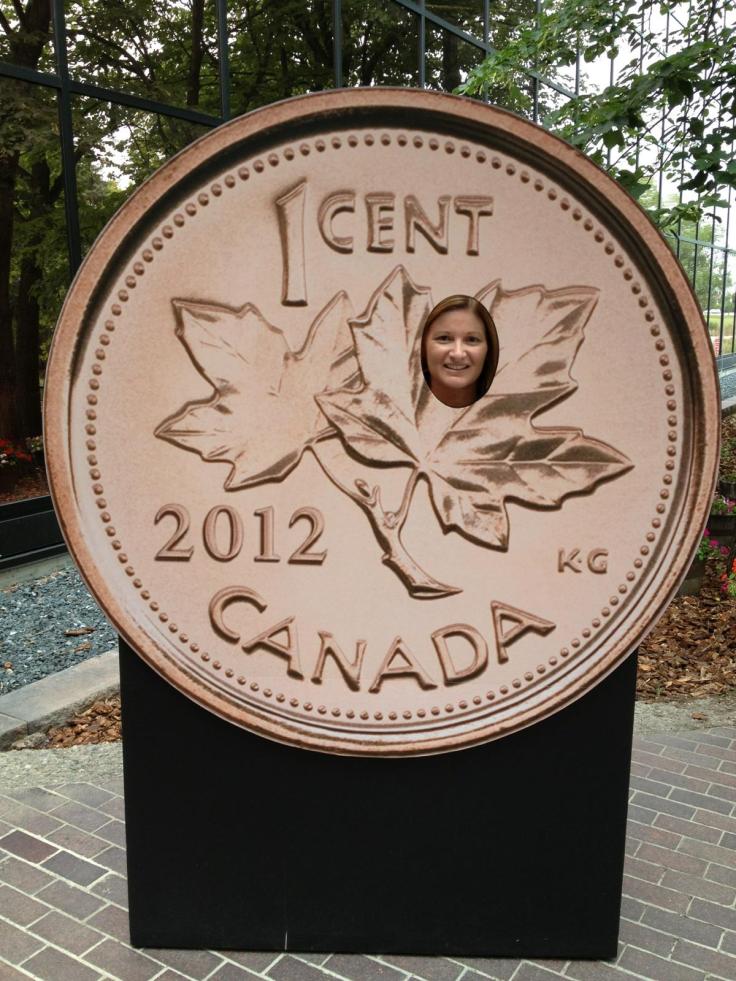 Peeking out of a Canadian 1 cent coin (penny) at the Mint. 