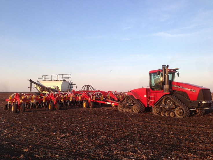A tractor pulls the air seeder. This unit is used to plant the seeds. 